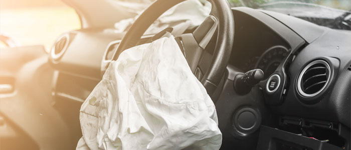 car interior with airbag deployed after an auto accident