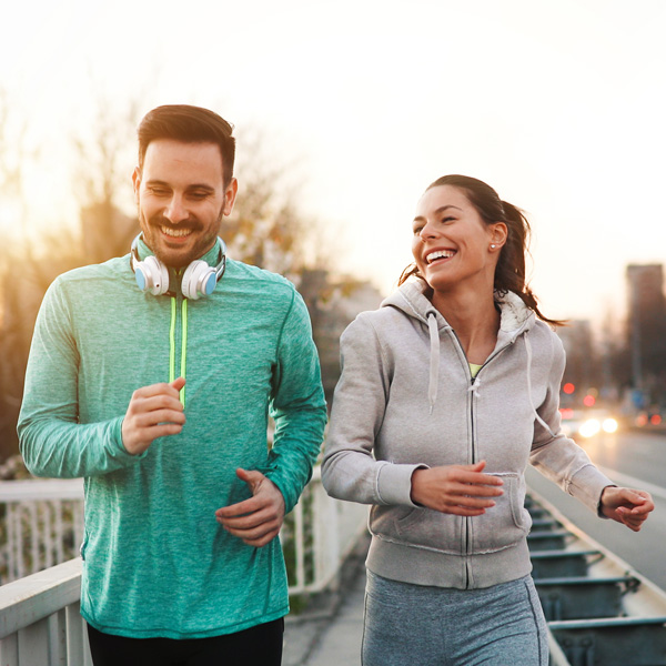 Couple smiling and running